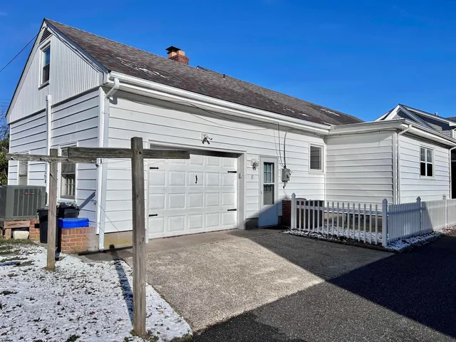 a view of a house with a backyard and wooden roof