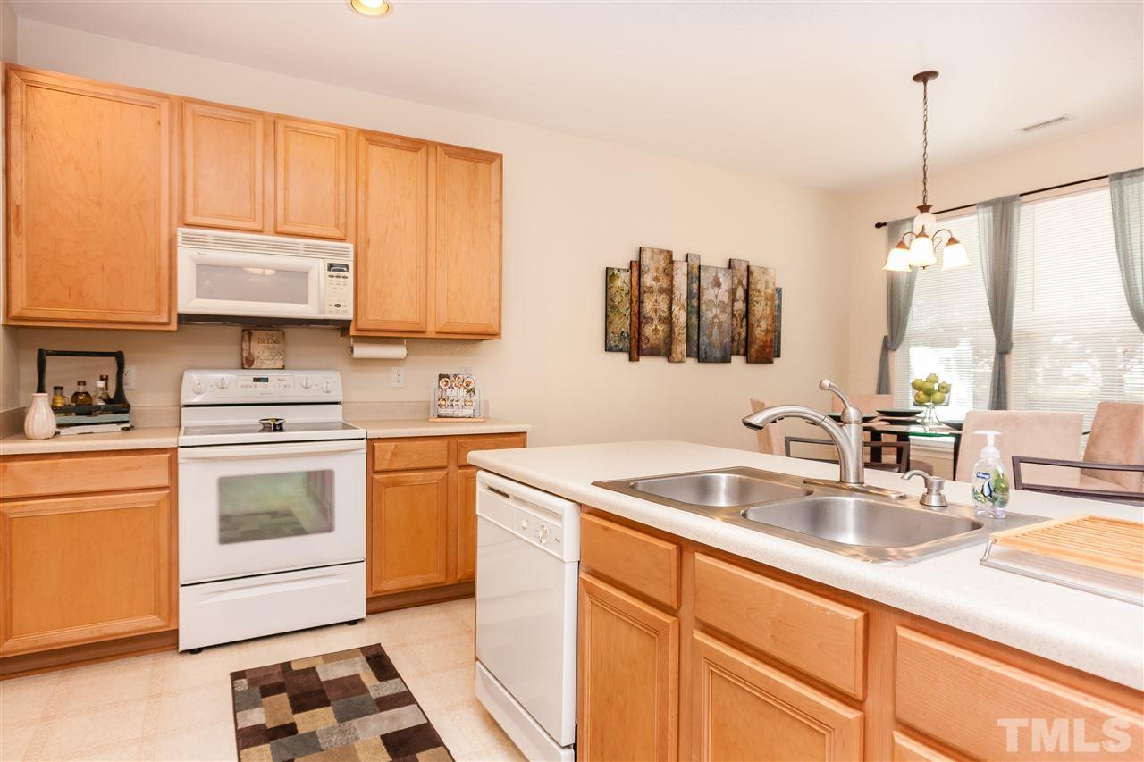8500 Pillar Gate Lane Raleigh, NC 27613 - Photo 11 of 24 a kitchen with a sink stove and cabinets