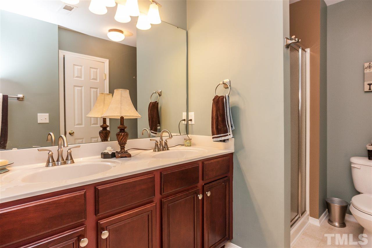 8500 Pillar Gate Lane Raleigh, NC 27613 - Photo 17 of 24 a bathroom with a double vanity sink mirror and toilet
