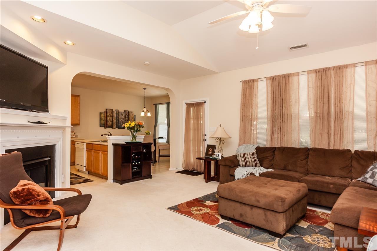 8500 Pillar Gate Lane Raleigh, NC 27613 - Photo 3 of 24 a living room with furniture a fireplace and a flat screen tv