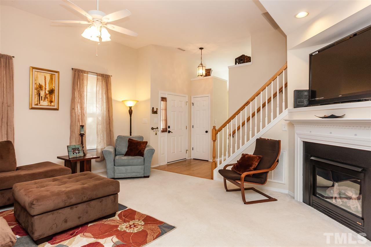 8500 Pillar Gate Lane Raleigh, NC 27613 - Photo 6 of 24 a living room with furniture a flat screen tv and a fireplace