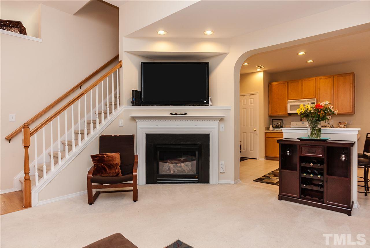 8500 Pillar Gate Lane Raleigh, NC 27613 - Photo 7 of 24 a living room with furniture a flat screen tv and a fireplace