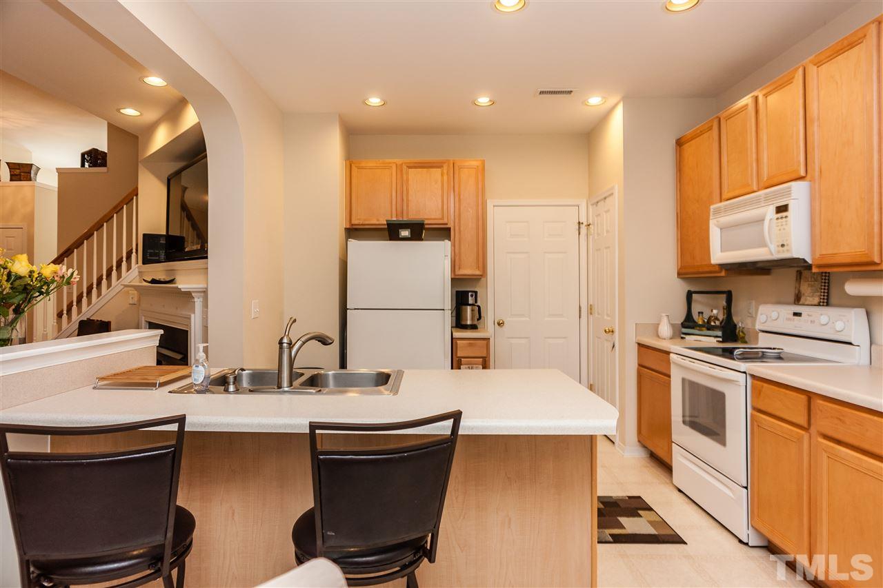 8500 Pillar Gate Lane Raleigh, NC 27613 - Photo 8 of 24 a kitchen with a sink appliances and cabinets