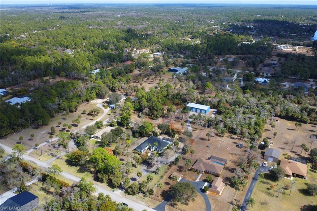 730 29th Street Southwest Naples, FL 34117 - Photo 47 of 50 Aerial overview of property's location with a heavily wooded area and nearby suburban area