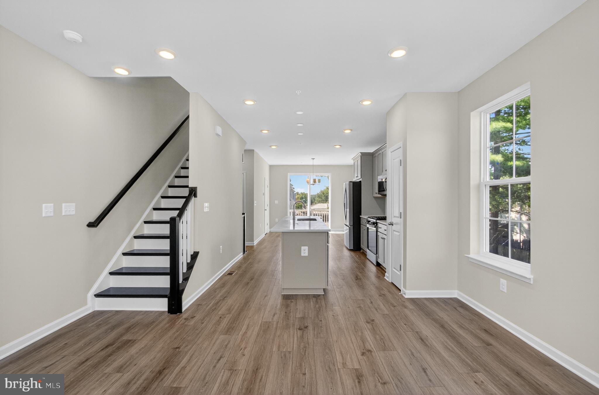 10046 Harper Vale Road Montgomery Village, MD 20886 - Photo 4 of 15 a view of entryway with stairs and wooden floor