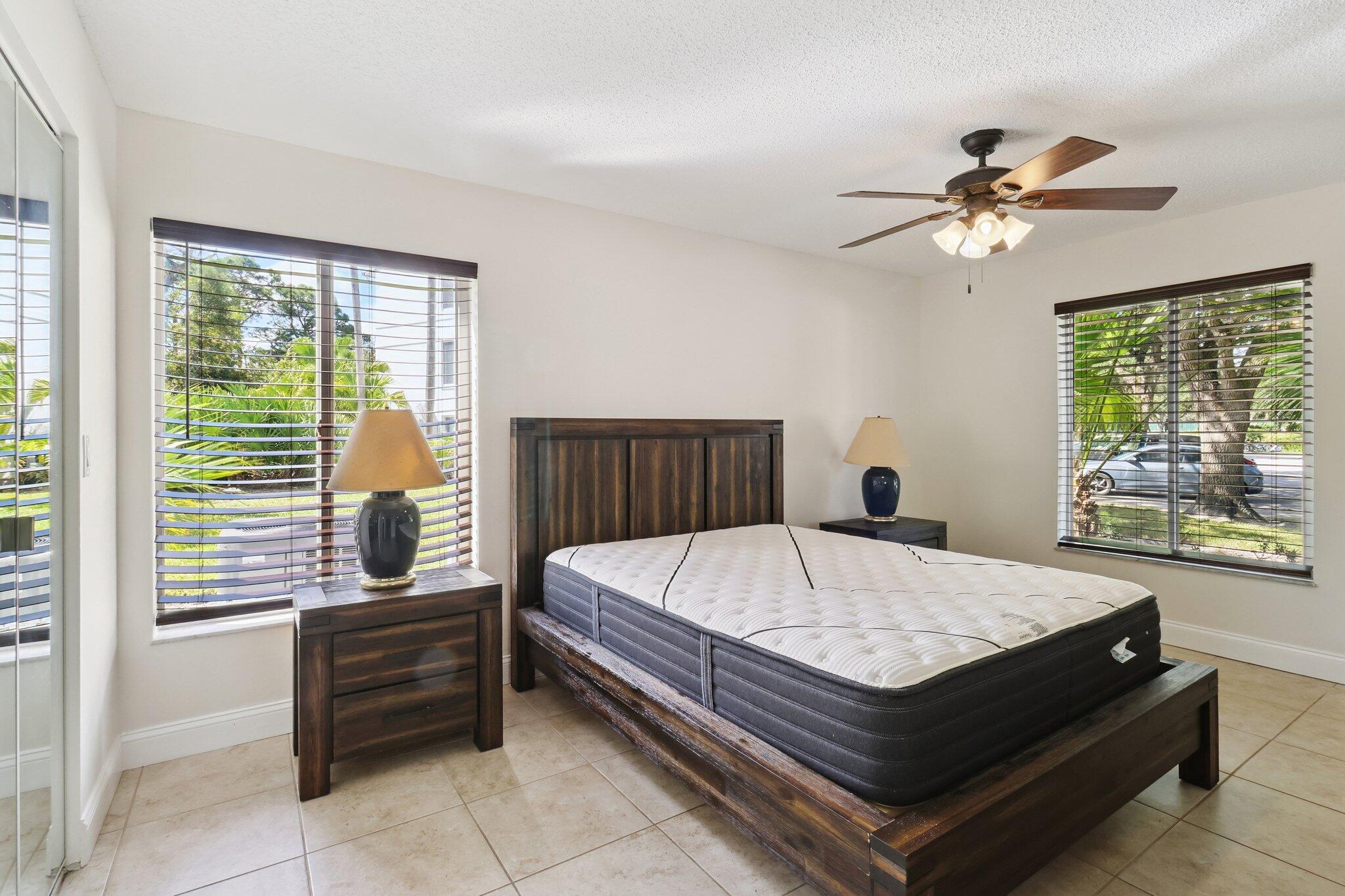 2500 Southeast Anchorage Cove, Unit D1 Port St. Lucie, FL 34952 - Photo 11 of 29 a bed sitting in a bedroom next to a window