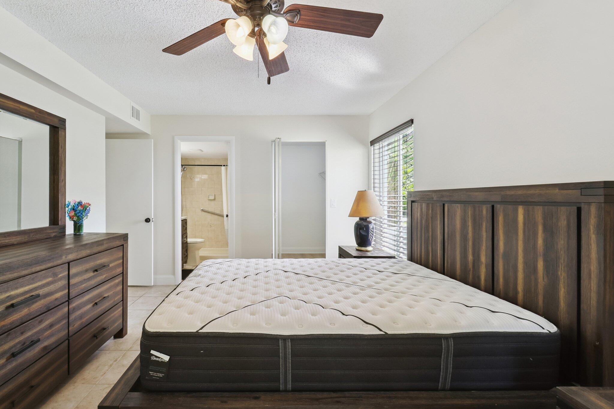 2500 Southeast Anchorage Cove, Unit D1 Port St. Lucie, FL 34952 - Photo 12 of 29 a bedroom with a large bed and a dresser