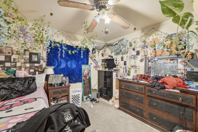 a bedroom with lots of wooden furniture and a chandelier