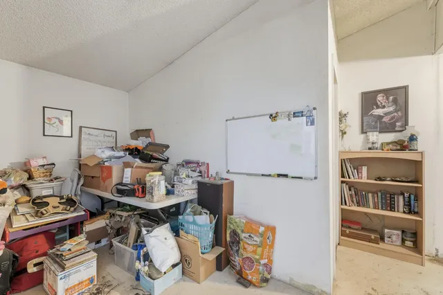 a view of a workspace with furniture and a bedroom