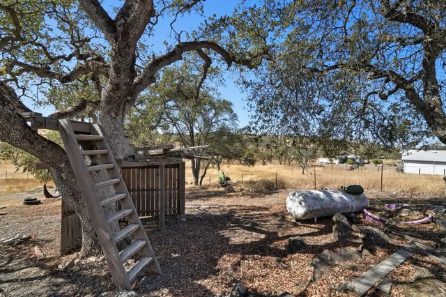 a view of a yard with iron fence