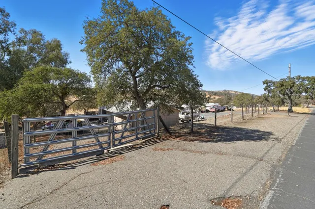 a view of a yard with wooden fence