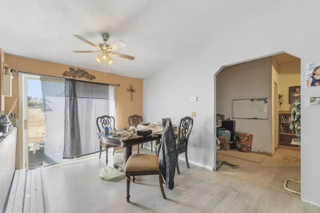 a view of a dining room with furniture and a chandelier