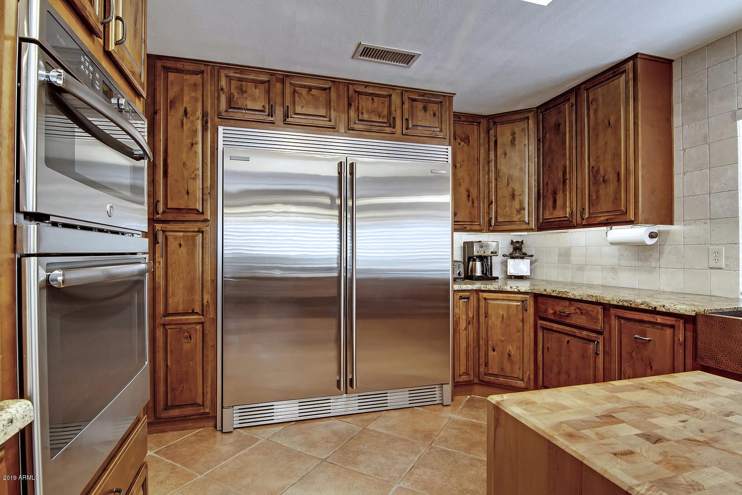 19009 East Wiki Way Rio Verde, AZ 85263 - Photo 11 of 55 a kitchen with stainless steel appliances granite countertop a refrigerator and a sink