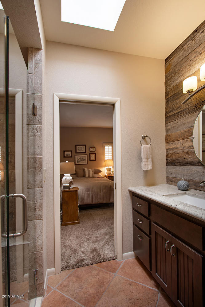 19009 East Wiki Way Rio Verde, AZ 85263 - Photo 34 of 55 a en suite bathroom with a sink a mirror and shower