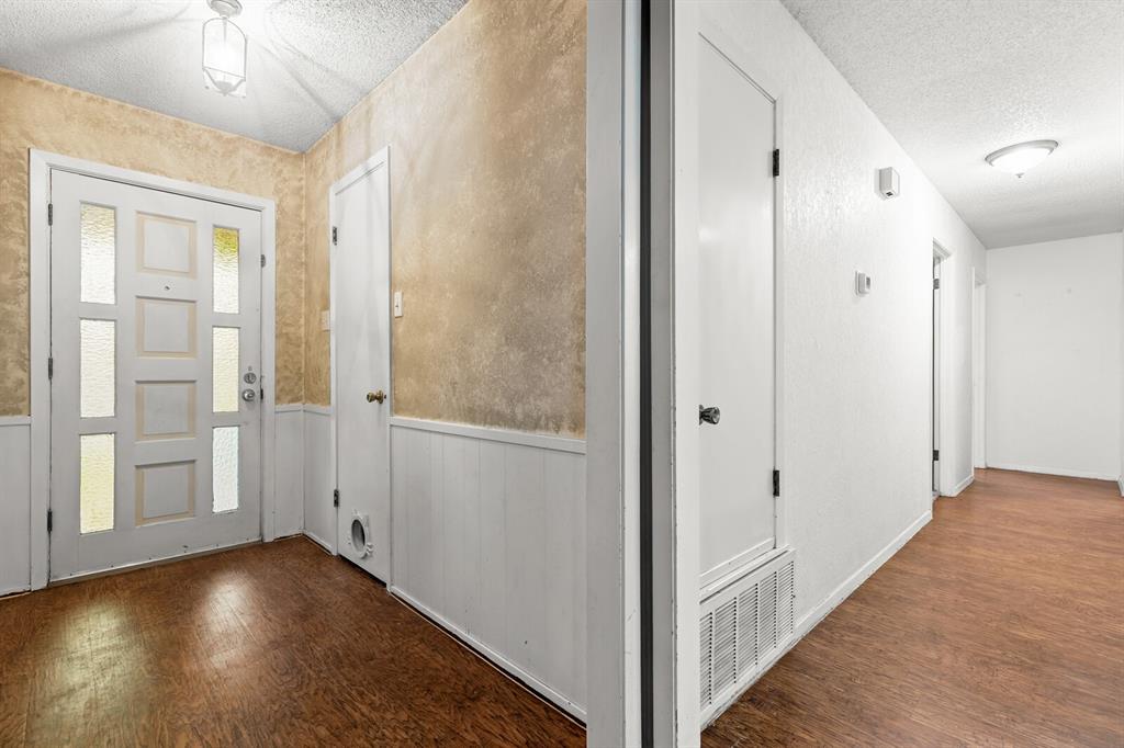 505 Pinewood Lane Hewitt, TX 76643 - Photo 2 of 38 Entryway with wood-finish flooring, white paneled wainscoting, and a white front door featuring multiple frosted glass inserts