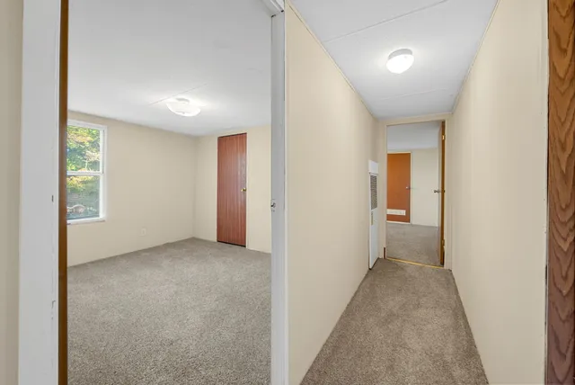 a view of a hallway with a window