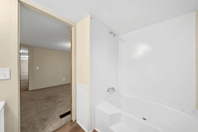 a bathroom with a bathtub and a shower