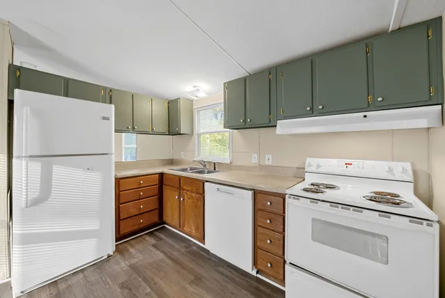 a kitchen with a stove cabinets and refrigerator