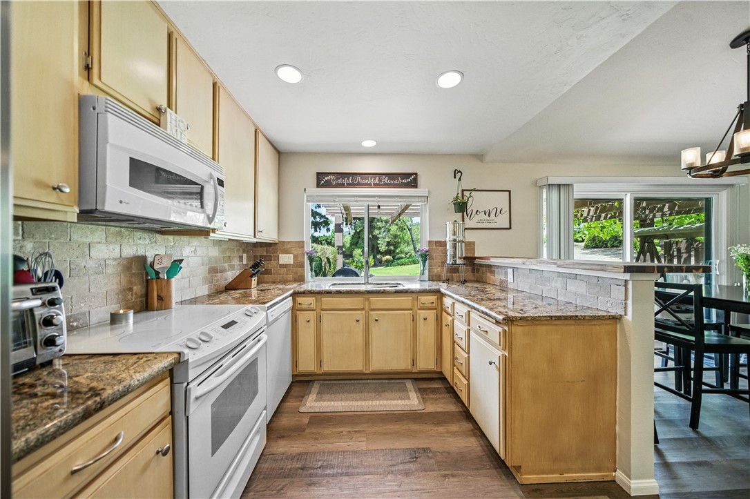 2113 David Drive Escondido, CA 92026 - Photo 12 of 46 a kitchen with stainless steel appliances granite countertop lots of counter top space and wooden floor