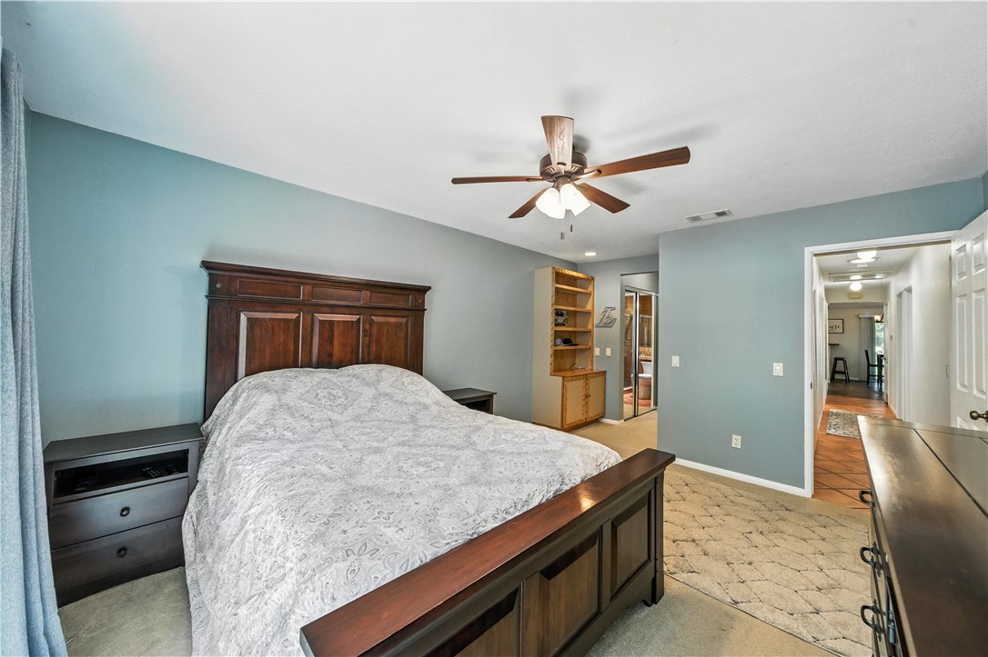 2113 David Drive Escondido, CA 92026 - Photo 25 of 46 a bedroom with a large bed and a chandelier