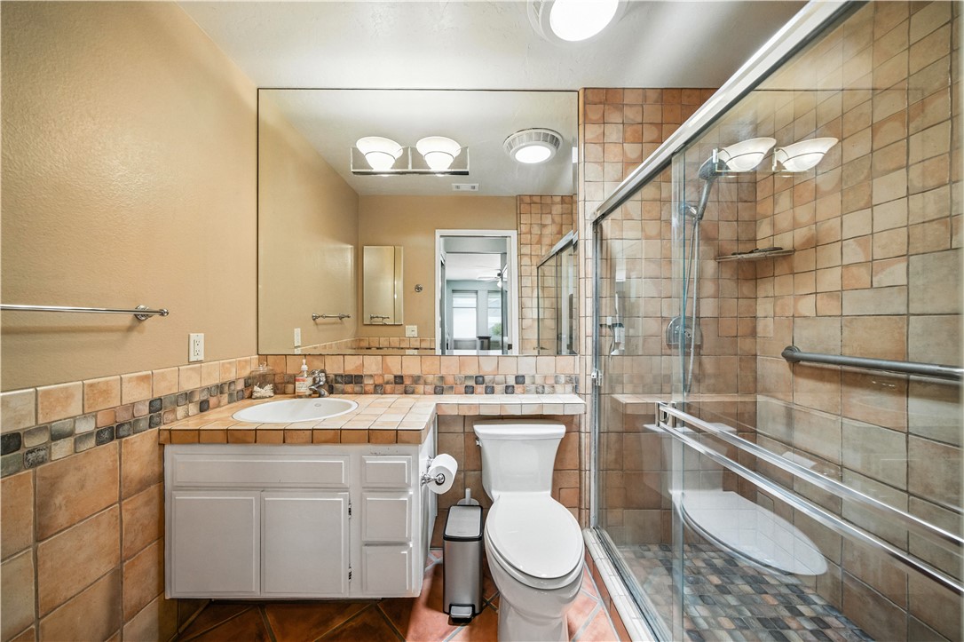 2113 David Drive Escondido, CA 92026 - Photo 28 of 46 a bathroom with a sink mirror vanity and toilet