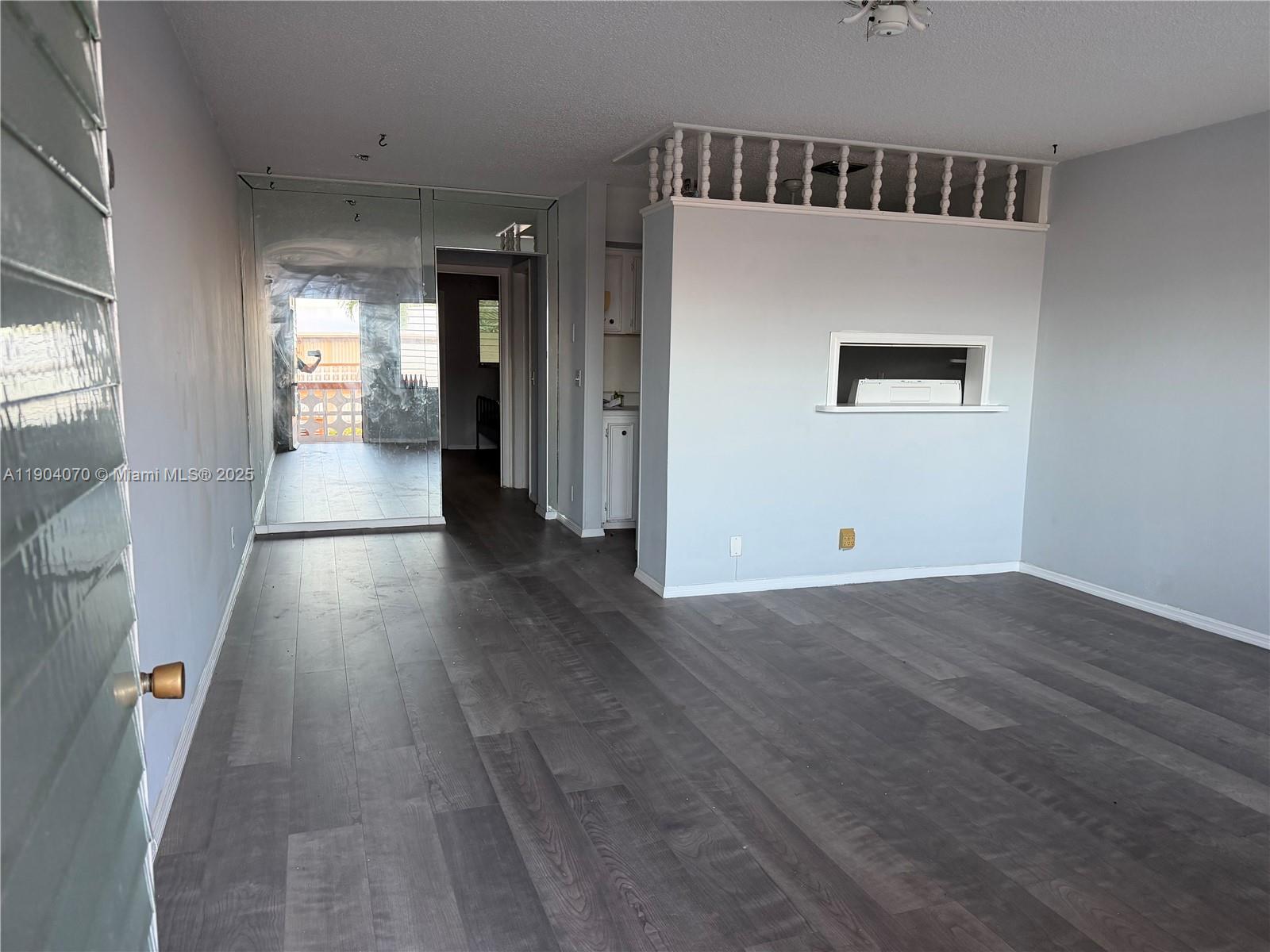 815 Southwest 10th Terrace, Unit 15V Hallandale Beach, FL 33009 - Photo 2 of 6 wooden floor in a hall with an entryway
