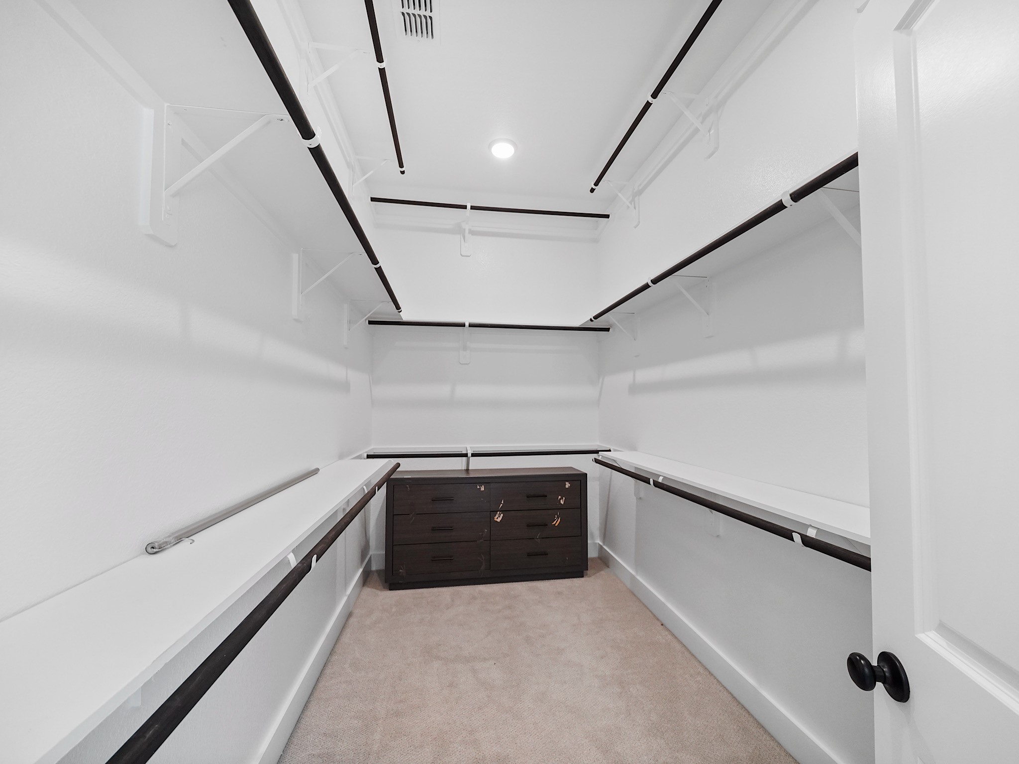 30214 Crossfield Road Fulshear, TX 77441 - Photo 20 of 42 The exceptionally large walk-in closet offers extensive hanging space, open shelving, and a central storage island.