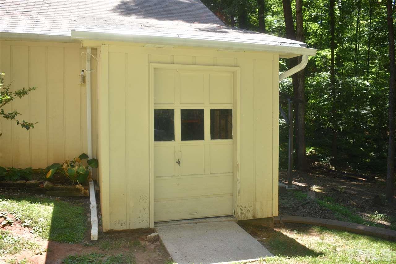 9621 Rock Creek Road Raleigh, NC 27613 - Photo 12 of 15 a yellow house with outdoor space