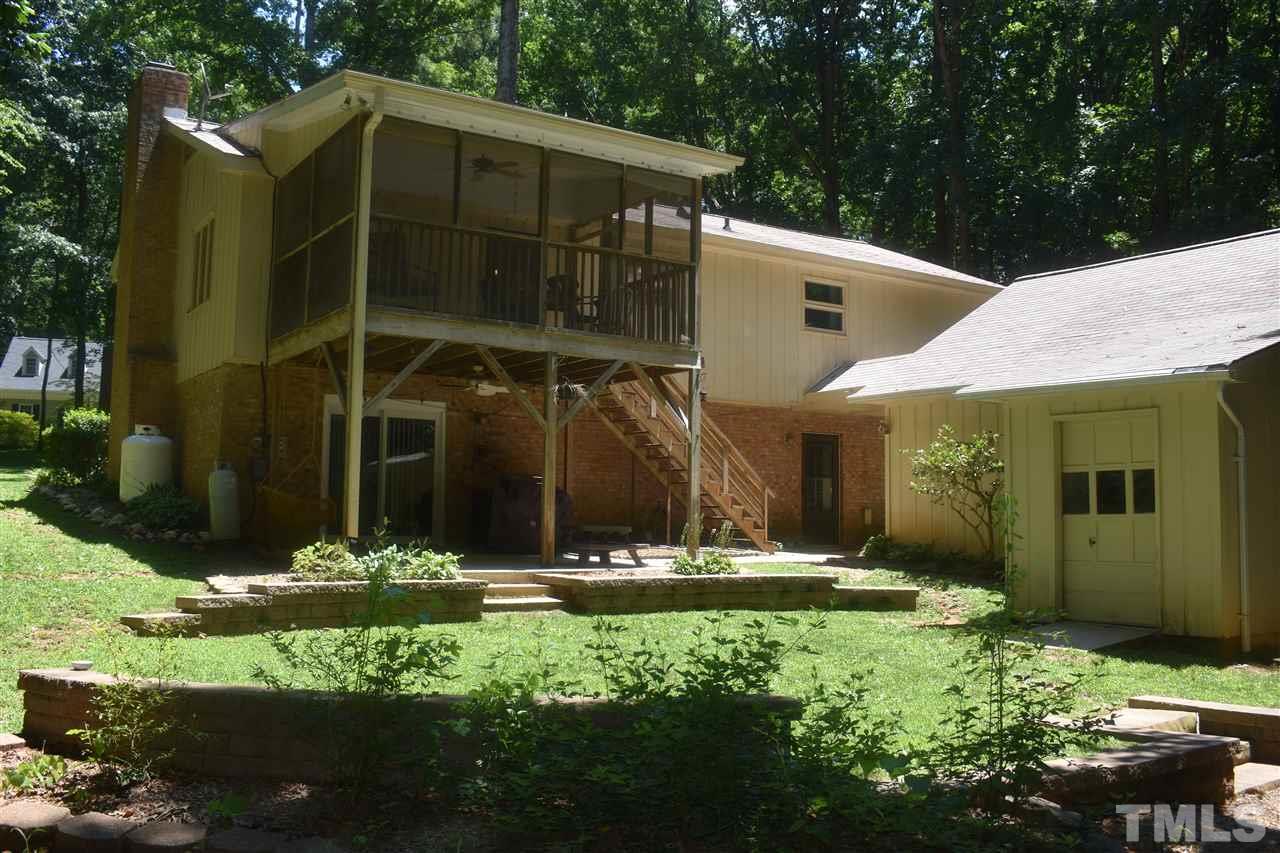 9621 Rock Creek Road Raleigh, NC 27613 - Photo 14 of 15 a front view of a house with garden