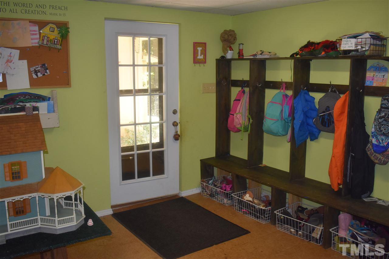 9621 Rock Creek Road Raleigh, NC 27613 - Photo 8 of 15 a view of a bedroom with baby crib and a window