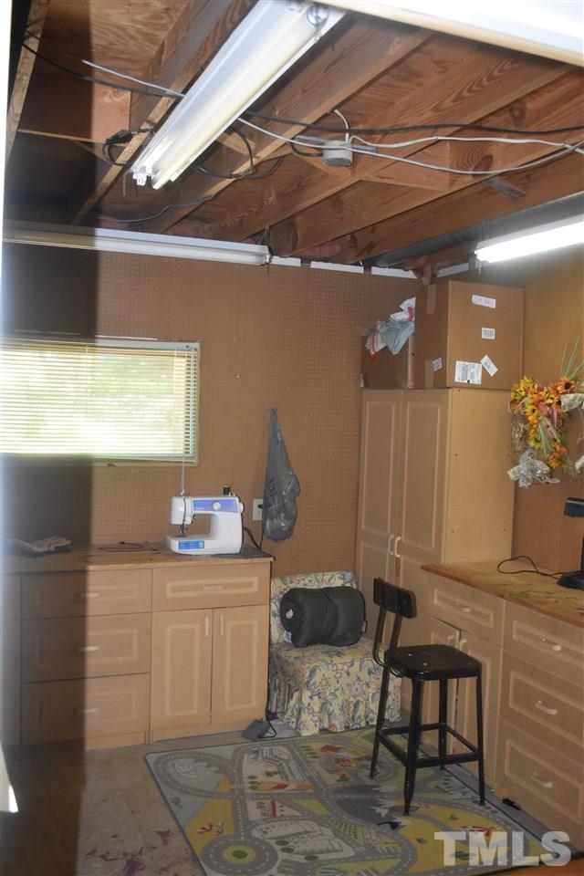 9621 Rock Creek Road Raleigh, NC 27613 - Photo 10 of 15 a room with table chairs and a wooden floor