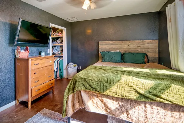 a bedroom with a bed and flat screen tv