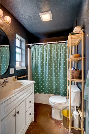 a bathroom with a sink toilet and a mirror