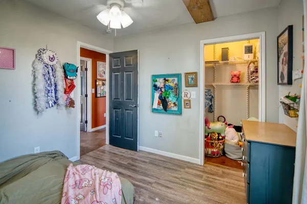 a bedroom with a bed and a window