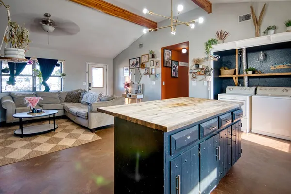 a living room with kitchen island furniture and a kitchen view