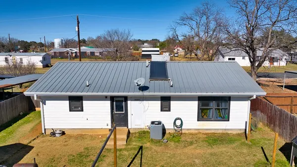 a view of house with backyard