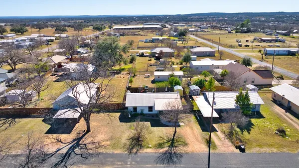 an aerial view of a residential houses with city view