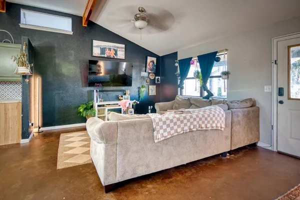 a living room with furniture and a flat screen tv