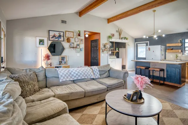 a living room with furniture and a chandelier
