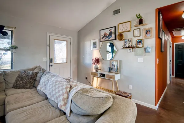 a living room with furniture and wooden floor