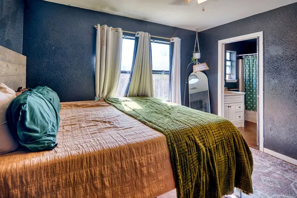 a bedroom with a bed and window