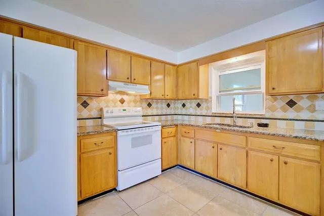 a kitchen with sink cabinets and window