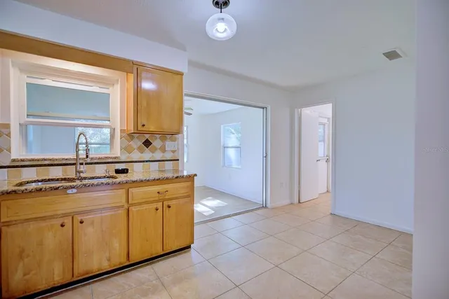 a spacious bathroom with a granite countertop sink and a mirror