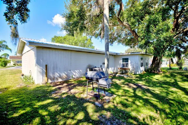 a backyard of a house with yard and outdoor seating