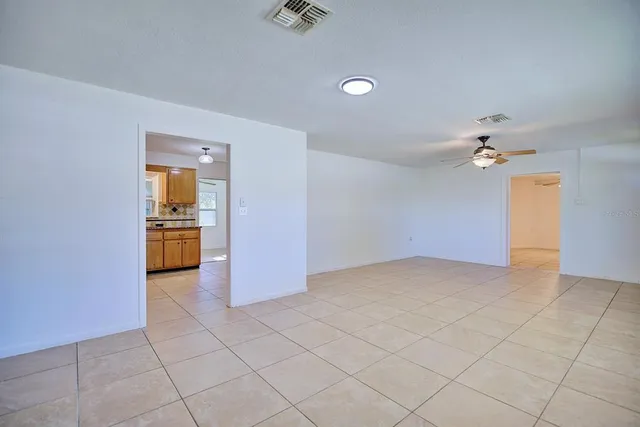 wooden floor in an empty room with a kitchen