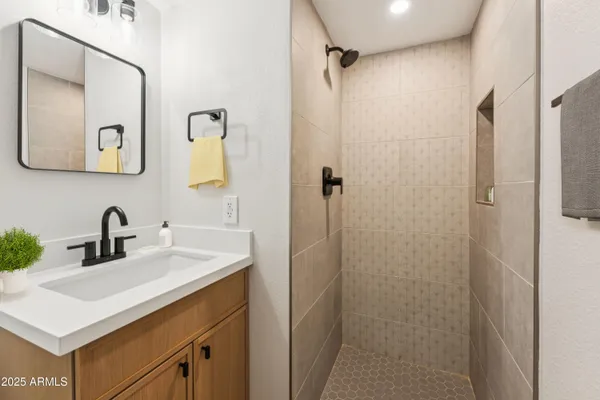 a bedroom with a bed and painting on the wall