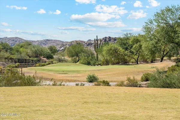 a view of a swimming pool with a table and chairs