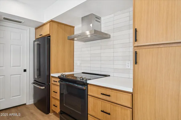 a view of a kitchen with a sink washer and dryer