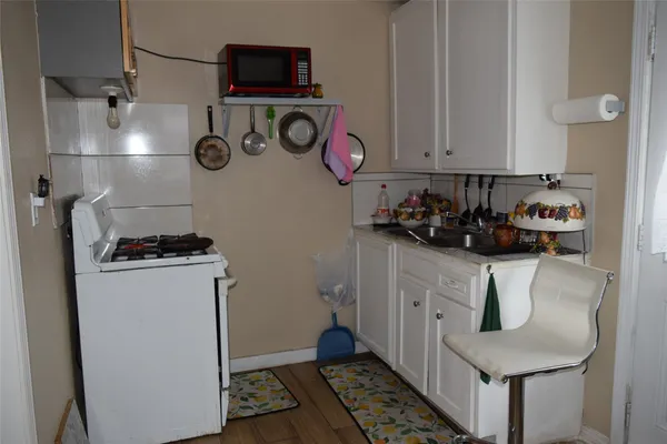 a kitchen with a refrigerator and a stove top oven