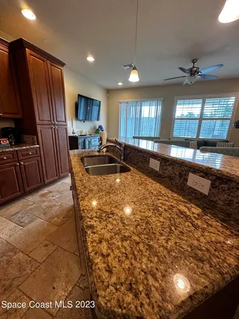 a kitchen with granite countertop a stove a refrigerator and a sink
